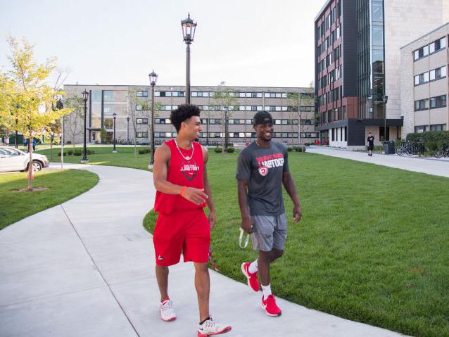 Students chat as they walk around campus.